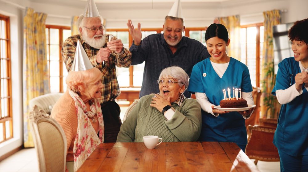 Residents and staff sharing a laugh over coffee